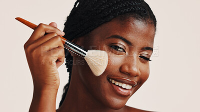 Buy stock photo Brush, makeup and black woman in studio with face, beauty or cosmetics for getting ready. Happy, cosmetology and African female person with blush for facial color or glow by white background.