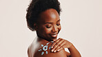 Sunscreen, skincare and shoulder with black woman in studio for beauty, uv protection and cosmetics. Glow, dermatology and spf lotion with person on white background for self care and sunblock cream