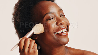 Buy stock photo Brush, powder and black woman in studio with face, beauty or cosmetics for getting ready. Happy, cosmetology and African female person with blush for facial color or glow by white background.