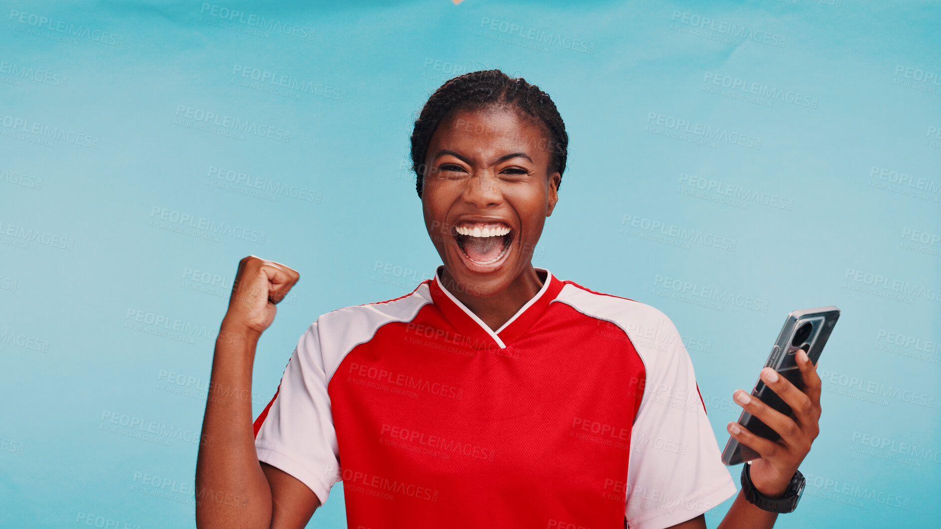 Buy stock photo Black woman, phone and success in studio for sports, excited and selection for soccer team by blue background. Girl, athlete and smartphone in portrait, good news and celebration for draft in USA