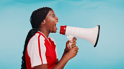 Buy stock photo Woman, loudspeaker and sports in studio with shout for inclusion, racism or fair pay in soccer by blue background. African athlete, girl and bullhorn for voice, profile or call to action for equality