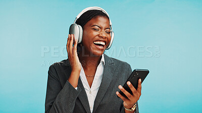 Buy stock photo Headphones, phone and business woman in studio to relax with audio, track and playlist. Professional, corporate and African person on smartphone listening to radio, song and music on blue background