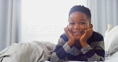 Buy stock photo Portrait, happy child and African boy in bedroom for relax, calm or wake up on weekend break. Face, smile and kid in home for resting, peace and comfort for growth or development in house in Nigeria