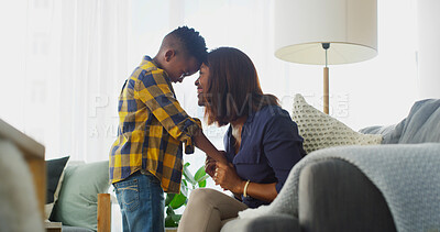 Buy stock photo Smile, mother and touch forehead with kid in home for care, love and family bonding together. African boy, mom and holding hands in living room for connection, support and relationship with parent