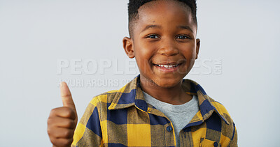 Buy stock photo Portrait, smile and boy with thumbs up in studio of good news, positive feedback and agreement. Happy, black child and space with emoji of thank you, voting and approval of winner on white background