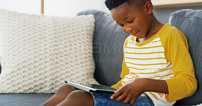 Buy stock photo Tablet, home and African kid online on sofa for reading ebook, learning app or streaming cartoon video. Relax, boy and child in living room on technology for entertainment, watch movies or play games