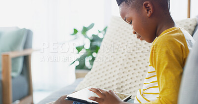 Buy stock photo Tablet, home and African child relax on sofa for reading ebook, learning app or streaming cartoon. Online, boy and kid in living room on technology to scroll entertainment, watch movies or play games