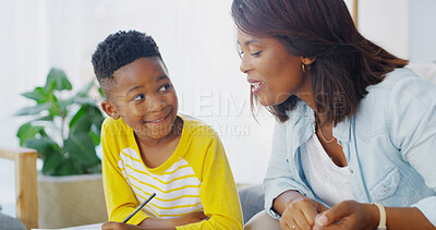 Buy stock photo House, woman and child with homework, writing and studying with son in living room, smile and care for boy. Home, mom and kid with notebook in lounge, knowledge or family in apartment with assignment