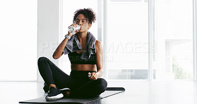 Buy stock photo Girl, gym and drinking water on floor, fitness and break with hydration, wellness and detox at training. Woman, bottle and liquid for health, electrolytes and benefits with rest at exercise club