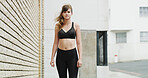 Portrait, fitness and woman in city for running, exercise or health activity with marathon training. Sports, wellness and female athlete with cardio workout for race endurance in urban town.