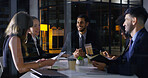 Discussion, business people and night meeting for deal, partnership and collaboration in office. Corporate, group and teamwork conversation in boardroom for planning, support or unity with documents