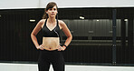 Woman, runner and earphones in city, training and perspective with start, exercise and audio tech. Girl, wellness and break with streaming subscription, sound and listen to music for fitness in Spain
