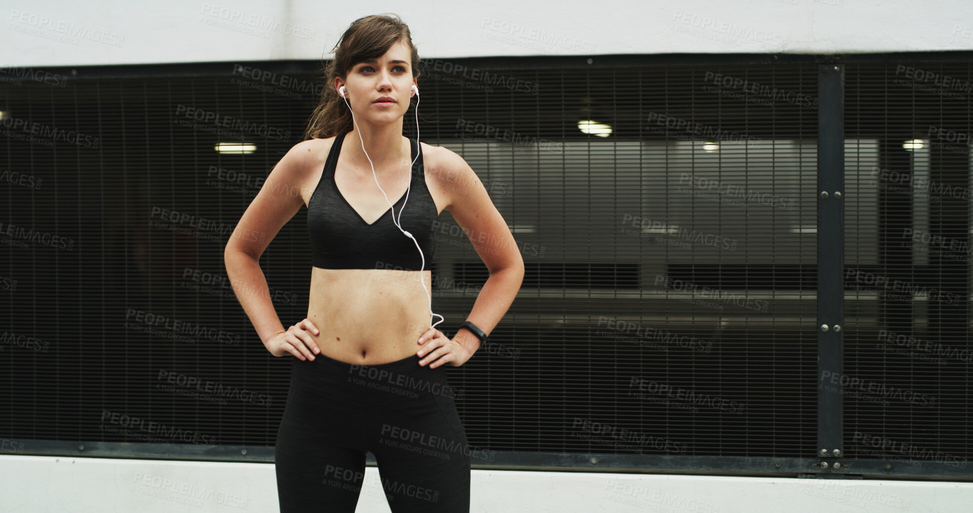 Buy stock photo Woman, runner and earphones in city, training and perspective with start, exercise and audio tech. Girl, wellness and break with streaming subscription, sound and listen to music for fitness in Spain