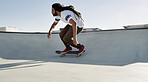 Skateboard, man and bowl outdoor for sport, exercise or competition challenge with space. African person, city and skate park for action, stunt performance or practice balance for hobby or cool trick