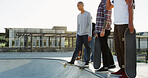 Skateboard, friends and men in city for sport, competition challenge or start exercise by bowl with space. Outdoor, fitness group or skate park for action, performance or balance with hands for hobby