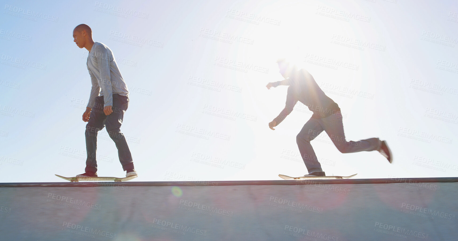 Buy stock photo Skateboard, friends and outdoor for sport, fitness competition and balance by bowl with space. Exercise, challenge and men at skate park for action, performance and flare for hobby in low angle