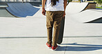 Back, legs and sports with person at skatepark for outdoor exercise, fun activity or hobby in summer. Action, skateboard and start with skater ready on ramp at venue for competition or tournament