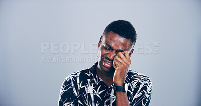 Buy stock photo Sad, black man and crying with emotion for breakup, cancelled vacation or mental breakdown in studio. Male person, African model or heartbroken with tears for bad news, disappointment or flight delay