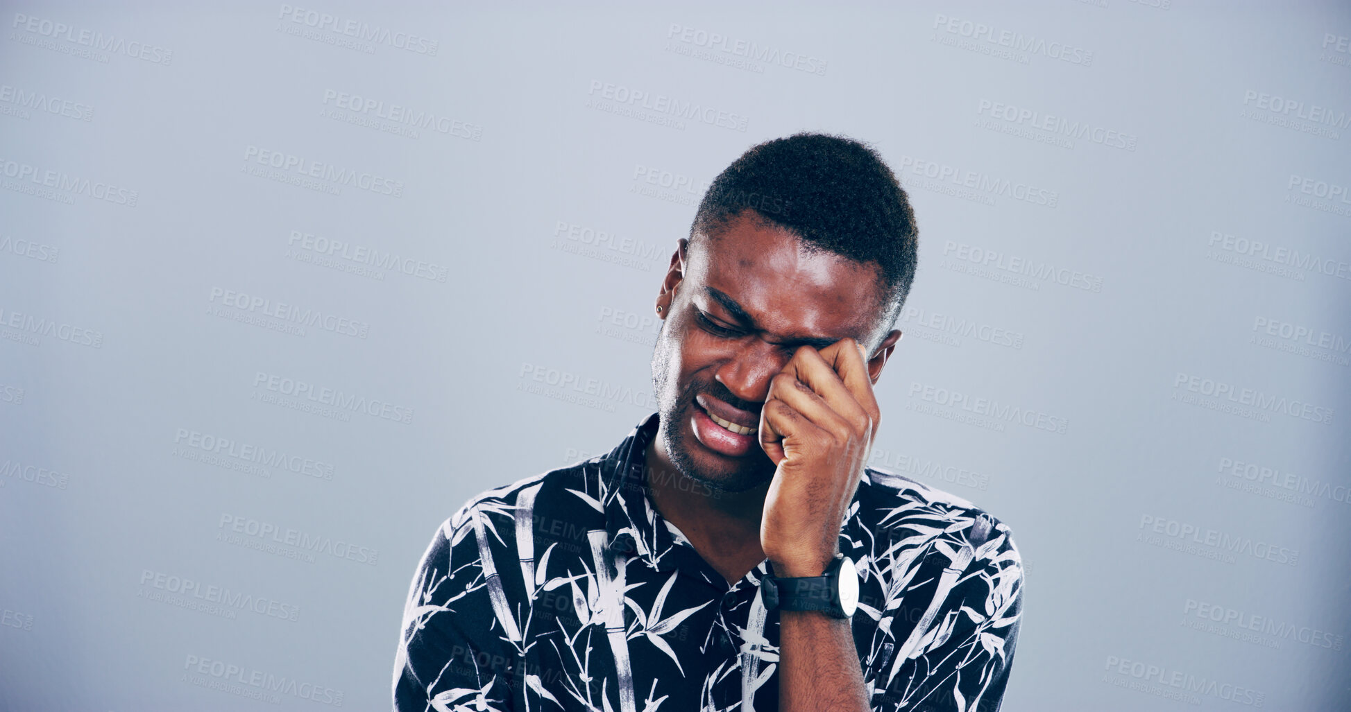 Buy stock photo Sad, black man and crying with emotion for breakup, cancelled vacation or mental breakdown in studio. Male person, African model or heartbroken with tears for bad news, disappointment or flight delay