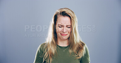 Buy stock photo Woman, sad and crying with sorrow in studio for mourning loss, broken heart and bad news. Person, mockup space and grief with depression, mental health and ptsd for trauma memory on gray background