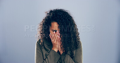 Buy stock photo Crying, sad and woman in studio, sorrow and emotional reaction on blue background. Person, model and depression with stress, shame or grief with loss, mourning and broken heart with breakup or trauma
