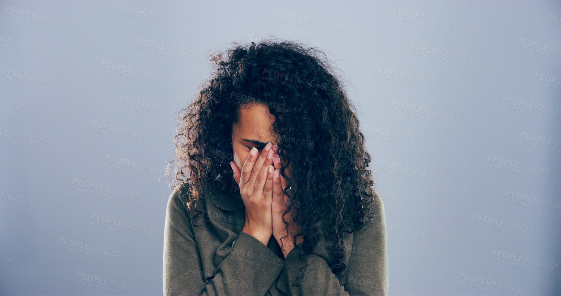 Buy stock photo Crying, sad and woman in studio, sorrow and emotional reaction on blue background. Person, model and depression with stress, shame or grief with loss, mourning and broken heart with breakup or trauma