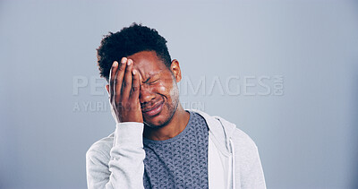 Buy stock photo Sad, black man or mistake with stress in studio for mental breakdown, anxiety or pain on a gray background. Male person, emotion or eye strain with headache for pressure or depression on mockup space