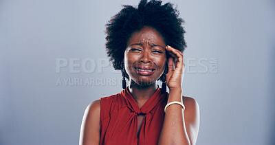 Buy stock photo Sad, black woman and crying with expression for grief, loss or mental breakdown on a studio background. Female person, model or heartbroken with afro, tears or emotional damage in sorrow for mourning
