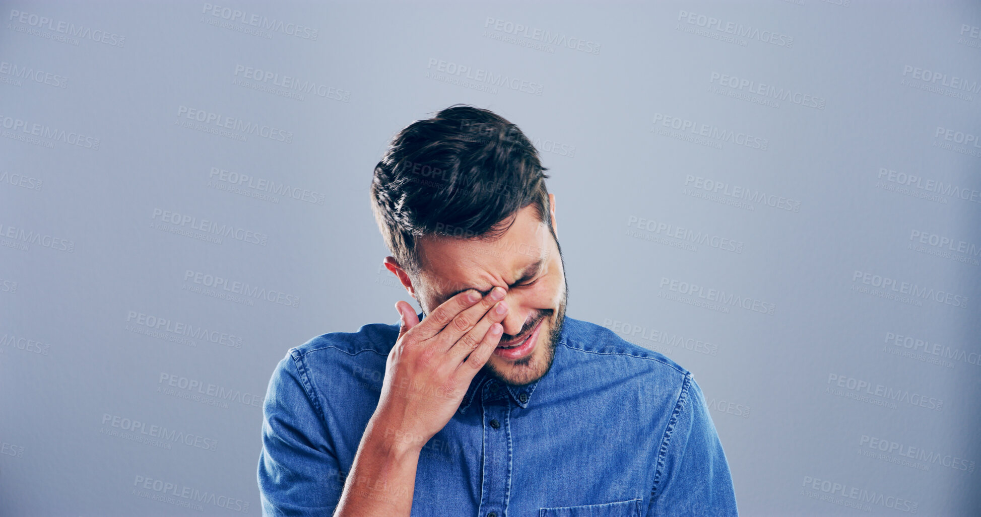 Buy stock photo Sad, man and crying with emotions in studio for mourning loss, broken heart and bad news. Person, mockup space and grief with depression, mental health and ptsd with trauma memory on gray background