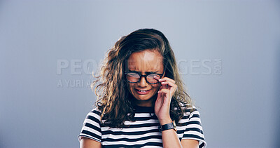 Buy stock photo Sad, girl and crying with emotions in studio for mourning loss, broken heart and bad news. Person, mockup space and grief with depression, mental health and ptsd for trauma memory on gray background