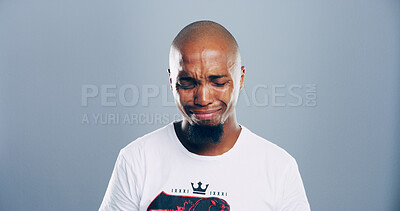 Buy stock photo Sad, black man and crying tears in studio for mourning loss, broken heart and bad news. Person, mockup space and grief of depression sorrow, mental health and ptsd of trauma memory on gray background