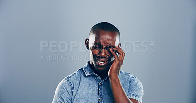 Buy stock photo Sad, black man and crying in studio with emotional breakup, mental breakdown and gray background. Male person, expression or sulk eyes with tears or broken heart for loneliness on mockup space