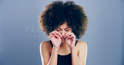 Buy stock photo Crying, sad and woman in studio, tears and emotional reaction on blue background. Person, model and girl with depression, stress and grief with loss, mourning and broken heart with sorrow and upset
