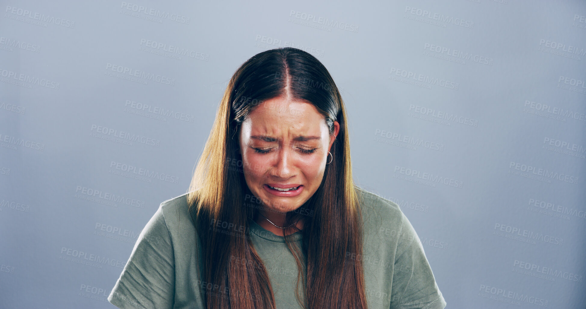 Buy stock photo Unhappy, woman and sad with crying in studio for broken heart, trauma and mourning loss. Mockup space, person and mental health on gray background with sorrow, break up and emotional from bad news
