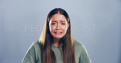 Buy stock photo Portrait, sad and woman crying in studio for mourning, broken heart and bad news. Grief, mockup space and female person with depression, mental health and ptsd for trauma memory on gray background