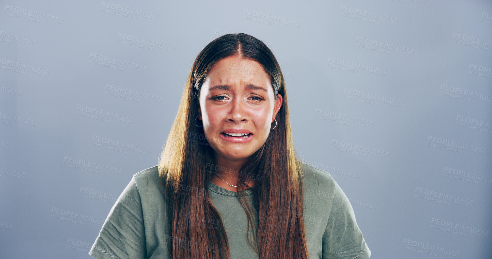 Buy stock photo Portrait, sad and woman crying in studio for mourning, broken heart and bad news. Grief, mockup space and female person with depression, mental health and ptsd for trauma memory on gray background