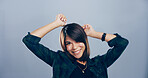 Dance, portrait and smile of excited woman in studio for celebration, clubbing or party fun. Energy, moving and music with happy dancer person on gray background mockup for choreography or rhythm