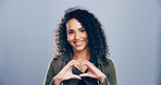 Woman, portrait and heart hands with love sign, gesture or romance on grey background space in studio. Journalist person, smile and emoji or shape, symbol and kindness for opinion and support mockup