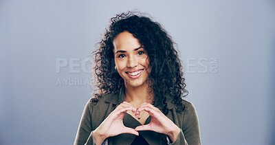 Buy stock photo Woman, portrait and heart hands with love sign, gesture or romance on grey background space in studio. Happy person, smile and emoji or shape, symbol and kindness for opinion and support mockup