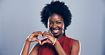 Black woman, portrait and heart hands with love sign, gesture or romance on grey studio background space. African person, smile and emoji or shape, symbol and kindness for valentines day date mockup