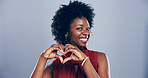 African woman, portrait and heart hands with love sign, gesture or romance on grey studio background space. Black person, smile and emoji or shape, symbol and kindness for valentines day date mockup