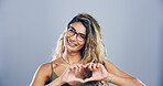 Woman, portrait and heart hands with love sign, gesture or romance on grey background space in studio. Happy person, smile and emoji or shape, symbol and kindness for valentines day date mockup