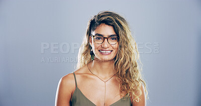 Buy stock photo Smile, creative and portrait of woman in studio with confidence, mockup space and gen z style. Artist, fashion designer and happy face of small business professional on gray background with glasses