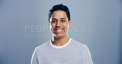 Buy stock photo Fashion, studio and portrait of man, clothes or happy for scholarship in university, trendy or outfit. Mockup space, blue background and person with stylish tshirt, student or guy with smile in India