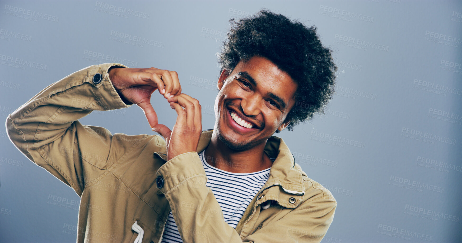 Buy stock photo Student, portrait and heart hands with love gesture, emoji and support on grey background space in studio. Happy man, smile and sign or shape, symbol and kindness for valentines day date mockup
