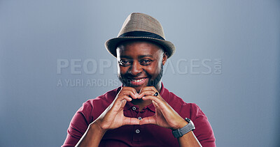 Buy stock photo Heart hands, portrait and smile with African man in studio for affection, love or romance. Emoji, hat and social media with happy black person on gray background mockup for health or wellness gesture