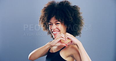 Buy stock photo Heart hands, portrait and smile with happy woman in studio for affection, love or romance. Afro, emoji and social media with flirty person on gray background mockup for health or wellness gesture