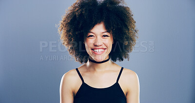 Buy stock photo Happy woman, portrait and studio with afro for hairstyle, positive attitude or expression. Creative, female person or model with smile, friendly emotion or self confidence on a gray background
