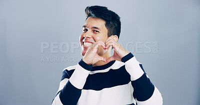 Buy stock photo Love sign, heart hands and portrait of man for support with charity or health isolated on gray background. Mockup space, smile and emoji for care, romance or wellness with symbol or shape in studio