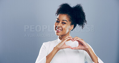 Buy stock photo Student, portrait and heart hands with love emoji, gesture and support on grey background space in studio. African woman, smile and sign or shape, symbol and kindness for valentines day date mockup